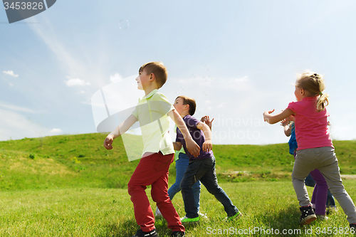 Image of group of happy kids running outdoors