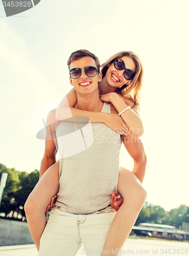 Image of smiling couple having fun in city