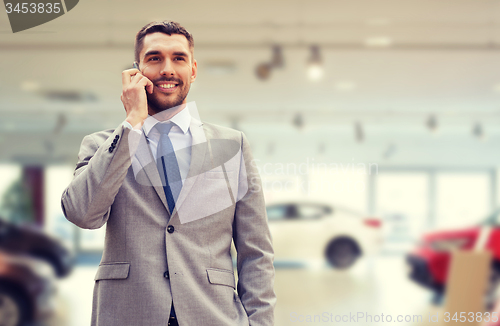 Image of smiling businessman talking on smartphone