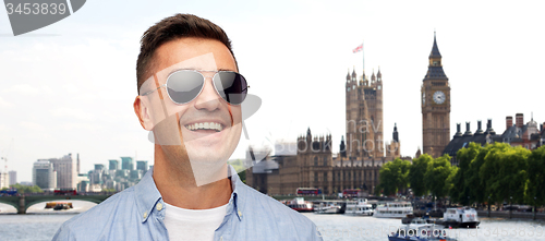 Image of face of smiling man in shirt and sunglasses