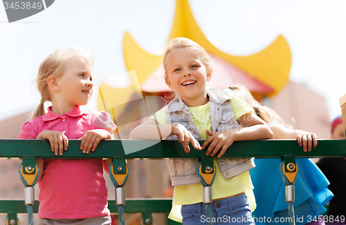 Image of happy little girls on children playground