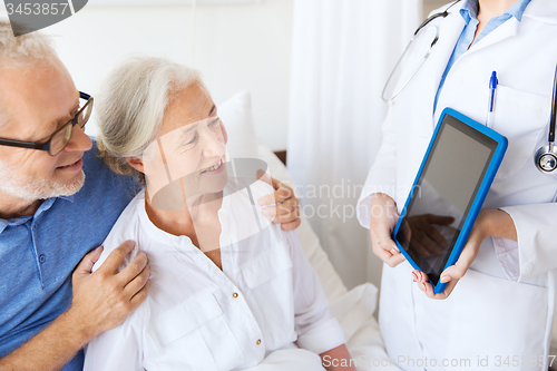 Image of senior woman and doctor with tablet pc at hospital