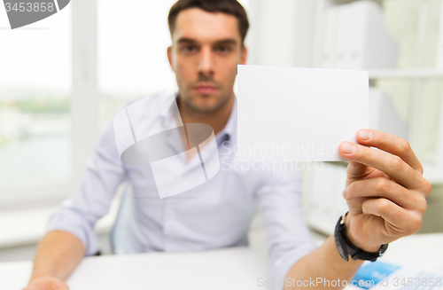 Image of close up of businessman with blank paper at office