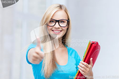 Image of smiling student with folders