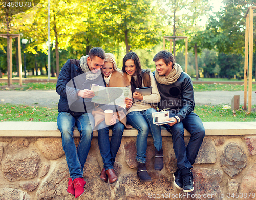 Image of group of friends with map outdoors