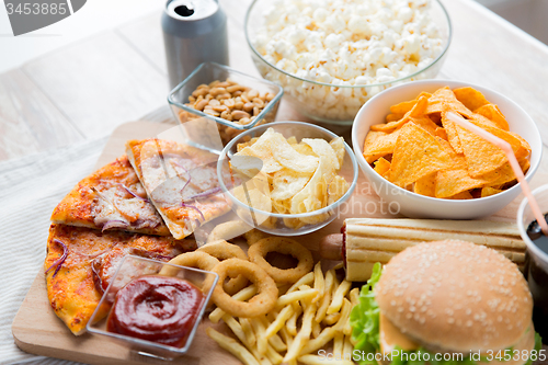 Image of close up of fast food snacks and drink on table