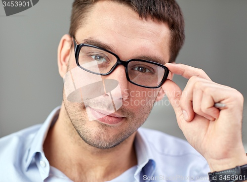 Image of portrait of businessman in eyeglasses at office