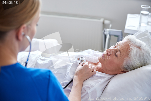 Image of nurse with stethoscope and senior woman at clinic