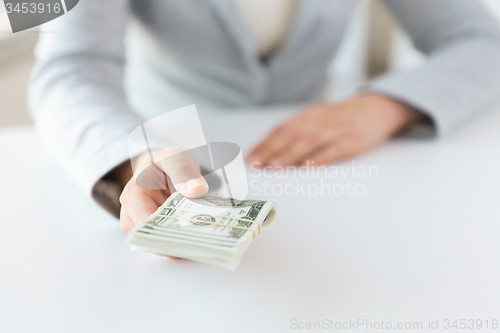 Image of close up of woman hands holding us dollar money