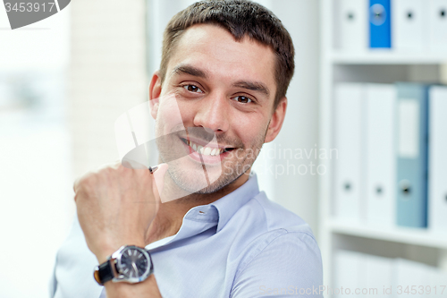 Image of portrait of smiling businessman in office