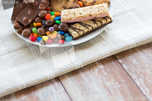 Image of close up of candies, chocolate, muesli and cookies