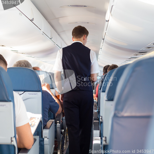 Image of Steward on the airplane.