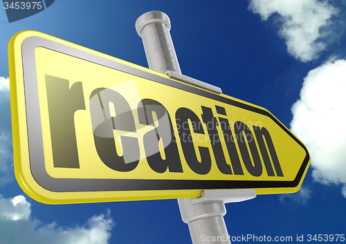 Image of Yellow road sign with reaction word under blue sky