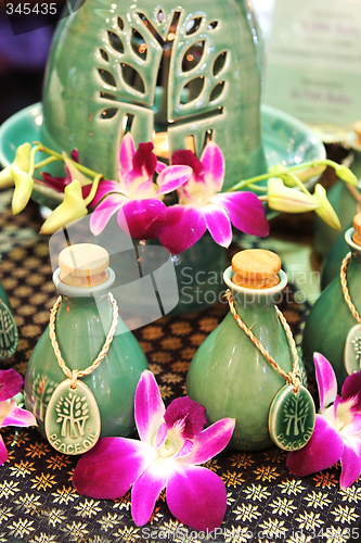 Image of Bottles of herbal spa oils and flowers.