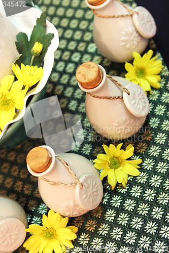 Image of Bottles of herbal spa oils and flowers.