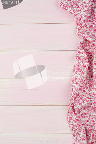 Image of Pink towel over wooden table