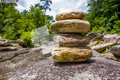 Image of Stack of round smooth stones near mountain river