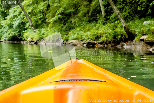 Image of view from kayak towards mountain river rushing waters
