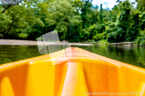 Image of view from kayak towards mountain river rushing waters