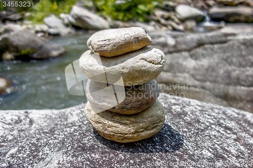 Image of Stack of round smooth stones near mountain river