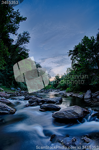 Image of river stream flowing over rocks