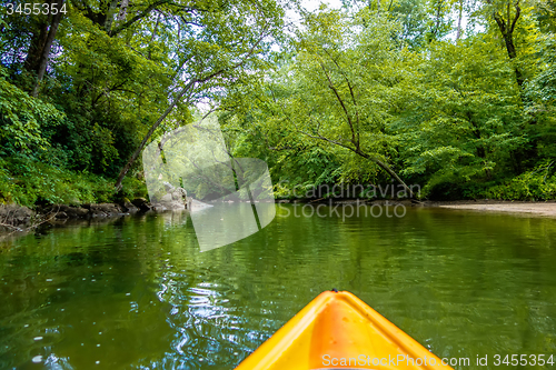 Image of view from kayak towards mountain river rushing waters