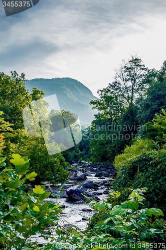 Image of river stream flowing over rock formations in the mountains