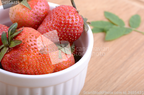 Image of Close up strawberry on wooden plate