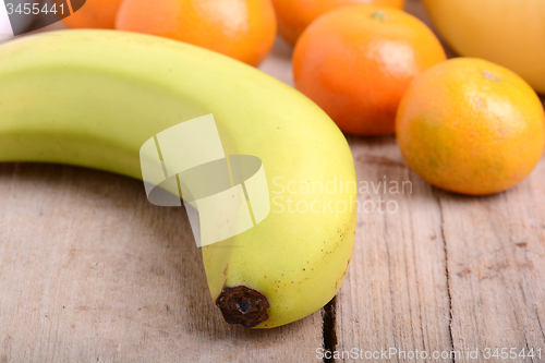 Image of Fresh colorful fruits composition mandarin, bananas and orange