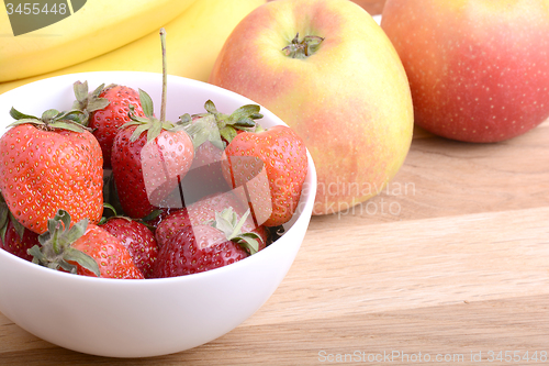 Image of Close-up shot of variety of fruits on old wooden plate