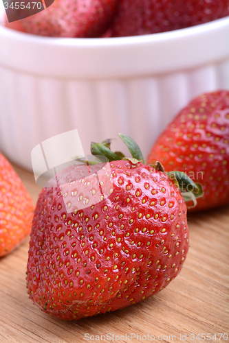 Image of Strawberry set on wooden plate close up