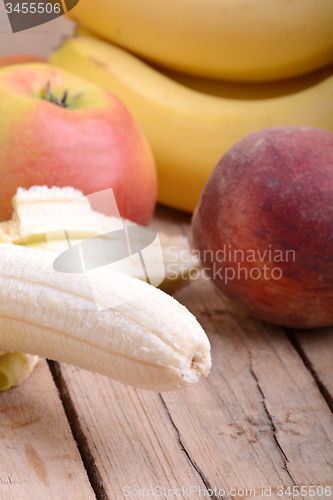 Image of fruits on table, apple, bananas, peach close up, health food concept