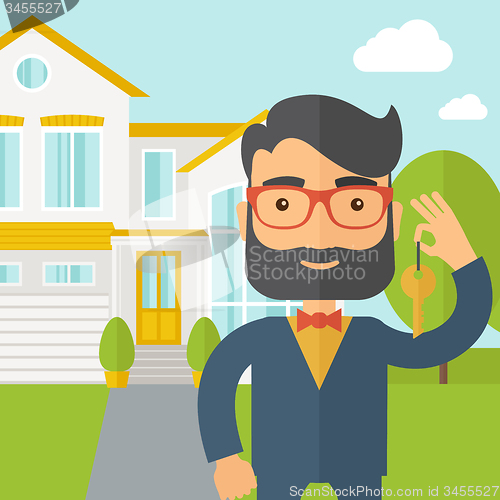 Image of Real estate agent holding a key infront of the house