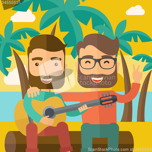 Image of Two men playing a guitar at the beach