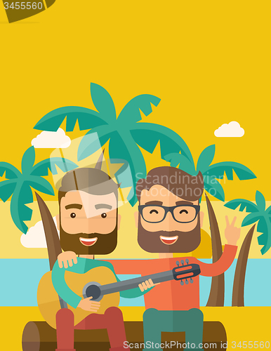 Image of Two men playing a guitar at the beach