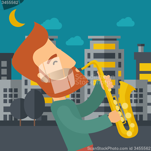Image of Saxophonist playing in the streets at night