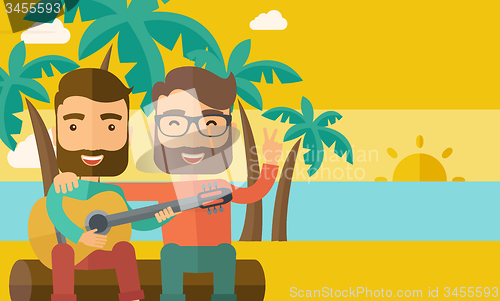 Image of Two men playing a guitar at the beach