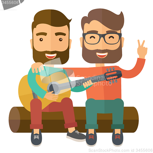 Image of Two men playing a guitar.