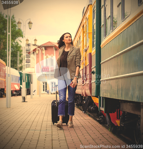 Image of beautiful middle-aged woman with a suitcase