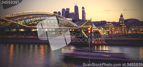 Image of Night cityscape Moscow city with bridge, river and motion boat