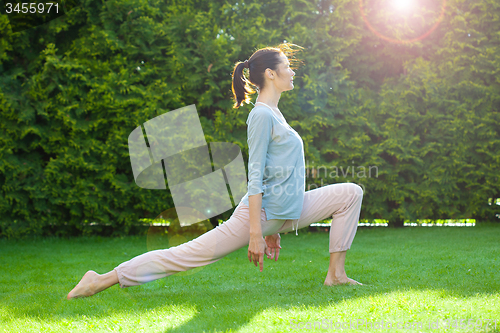 Image of pretty adult woman doing yoga