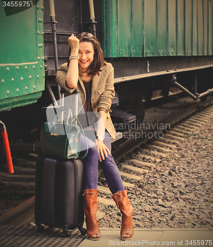 Image of beautiful woman traveler laughing