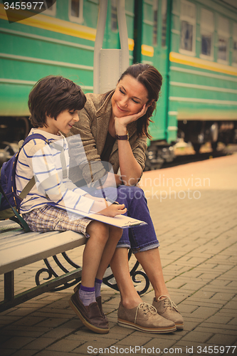 Image of mother and son on railroad station