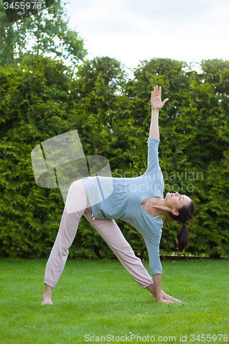 Image of pretty adult woman doing yoga