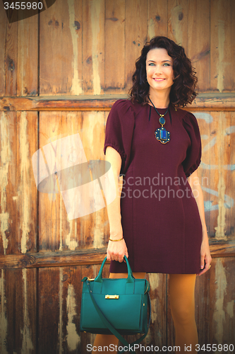 Image of beautiful middle-aged woman in a burgundy dress