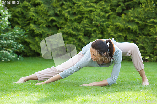 Image of pretty adult woman doing yoga