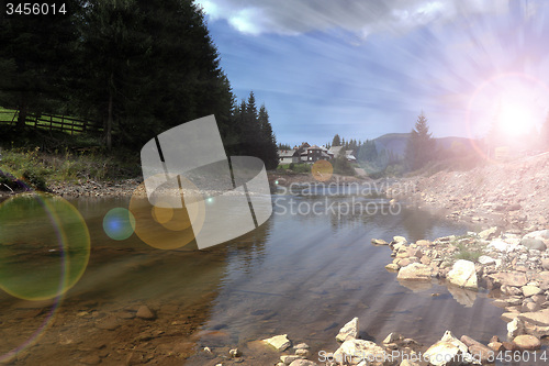 Image of sun rays over mountain river