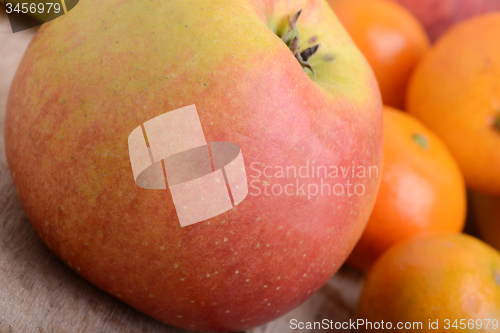 Image of Bananas apple mandarin peach strawberry on wooden background as health food concept