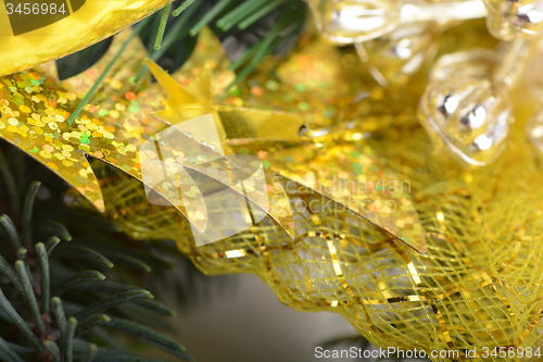 Image of Image of Christmas tree branch with golden material, festive border, New Year greeting card, magic night, glowing backdrop, xmas decoration, holiday ornament