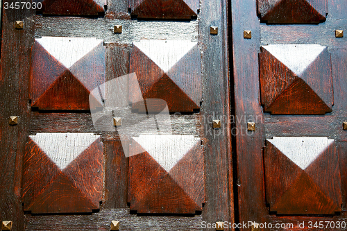 Image of  traditional   door    in italy   ancian wood   texture nail